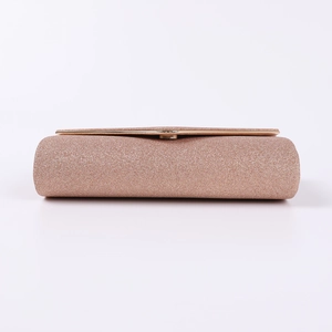 Detailed macro view of rose gold glitter evening clutch with elegant gold metal frame