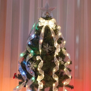 Silver LED ribbon with warm lights, star topper and snowflake ornaments for Christmas tree