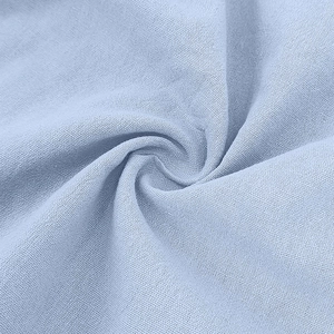 Close-up of light blue linen-cotton fabric showing soft texture and fine plain weave