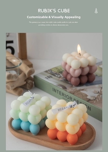 Detailed view of bubble cube scented candles with gradient colors and decorative ribbons