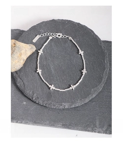 Detailed view of S925 sterling silver beaded bracelet on dark textured stone background