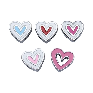 Macro detail of heart-shaped alloy beads for bracelets in multiple enamel colors