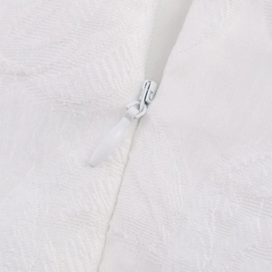 Elegant white short dress with textured floral patterns and a hidden zipper detail