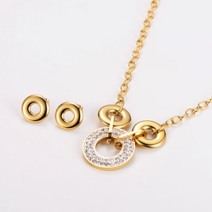 Detailed view of golden stainless steel jewelry set with sparkling pavé crystal rings