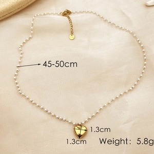 18K gold plated pearl necklace with heart pendant, 45-50cm length, on beige background