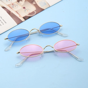 Retro oval metal sunglasses with trendy blue and pink lenses in a stylish golden frame