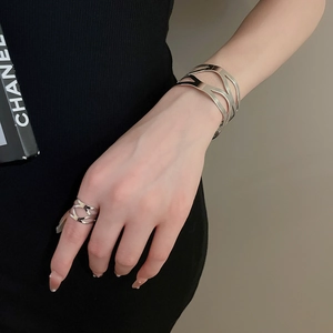 Detailed view of silver hollow geometric metal bracelet and matching open ring set