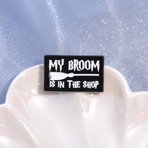 Creative magic alloy brooch featuring a black flying broomstick and humorous text design