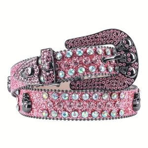 Pink rhinestone leather belt with glitter finish and black skull ornaments on white background