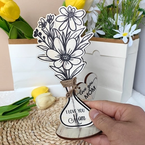 Detail of wooden flower ornament with I LOVE YOU MOM engraving and heart tag decoration