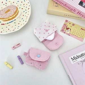 Detail of pink canvas earphone cases with star patterns and heart buckles