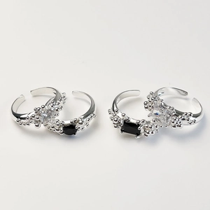 Macro detail of S925 silver open rings featuring black zircon stones and textured bands