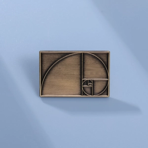 Minimalist bronze rectangular brooch with golden spiral design and brushed texture