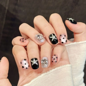 Pink and black leopard print press-on nails with silver glitter and 3D metal star accents