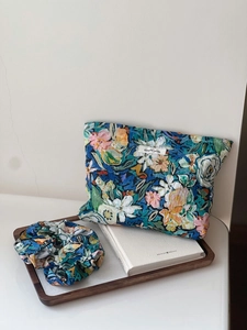 Close-up of floral cotton pouch and matching hair scrunchie with a simple wish label
