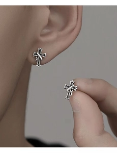 Close-up of vintage 925 sterling silver cross stud earrings for men with black details