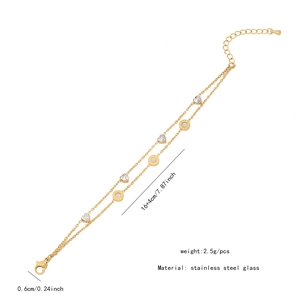 Close-up of golden double-layer stainless steel bracelet with heart and round charms