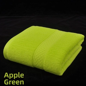 Macro detail of apple green cotton bath towel showing soft absorbent looped terry texture