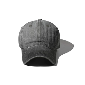 Macro detail of dark grey washed cotton baseball cap showing vintage fabric texture