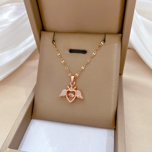 Rose gold heart necklace with angel wings and pink gemstone in jewelry gift box