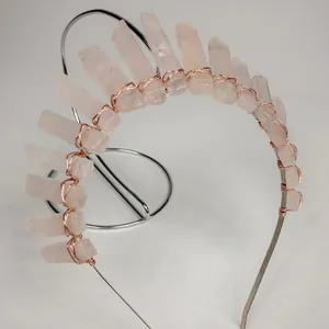 Detailed close-up of pink crystal raw stones hand-woven onto a rose gold bridal headband