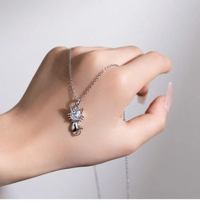Macro shot of a silver cat pendant necklace with a brilliant round cubic zirconia stone