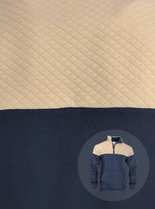 Detail of waffle quilted khaki fabric and navy blue jersey on men's pullover