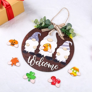 Detail of wooden welcome sign with interchangeable seasonal icons like pumpkin and heart
