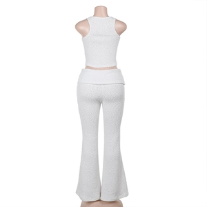 Back view of white textured knit set featuring a halter top and high-waisted flare pants
