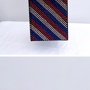 Close-up of a luxury rectangular evening clutch with vibrant rainbow rhinestone stripes