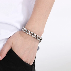 Retro 11mm Cuban link chain bracelet in silver titanium steel worn on a wrist
