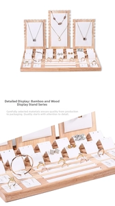 Detail of bamboo jewelry display set showing necklace stand and ring slots in wood
