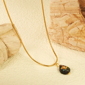 Golden snake chain necklace with abalone shell teardrop pendant and star stone accent