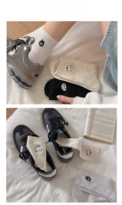 Detailed embroidery of cute cats on cotton crew socks in cream, black, and grey colors