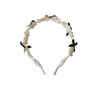 White ruffled headband with small black bows for a cute Lolita style hair accessory