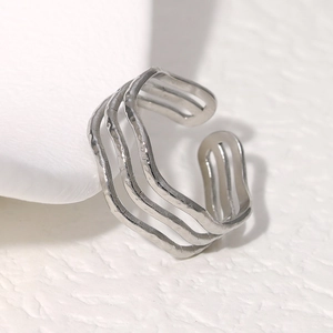 Minimalist silver multilayer wave pattern stainless steel open ring on a marble stone base
