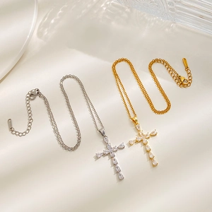 Cross pendant necklaces in gold and silver finish with zircon stones on silk fabric
