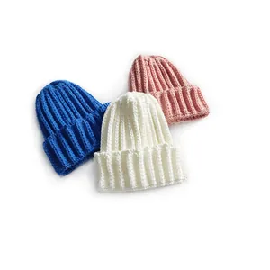 Thick ribbed knit beanie hats for kids and adults in blue, cream, and pink for winter