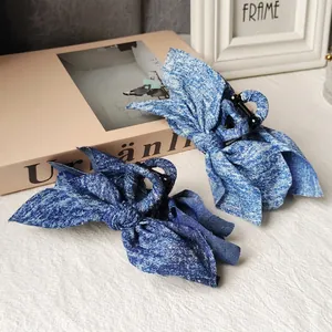Denim bow hair clips in light and dark blue with sparkling rhinestones for women