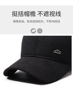 Close-up of winter baseball cap with side metal sport logo and textured corduroy fabric