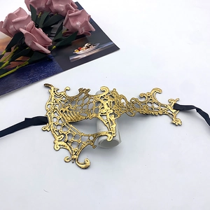 Detail of gold lace masquerade mask with intricate floral patterns for party use