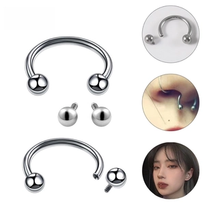 Detailed view of G23 titanium horseshoe ring with screw-on beads for body piercing