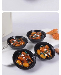 Makroansicht des realistischen Hühnersuppen-Food-Modell-Schlüsselanhängers mit glänzender Sauce