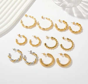 Detail view of 18K gold-plated C-shaped earrings with twisted and bamboo textures