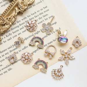 Mix of colorful cubic zirconia charms for DIY jewelry on vintage book pages