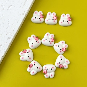 Set of nine cute white resin bunnies with pink strawberries for DIY crafts and phone cases