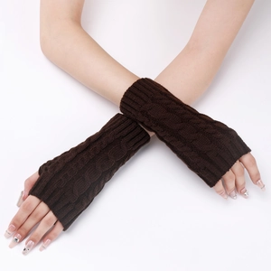 Close-up of deep brown cable-knit arm warmers with thumb holes and textured wool pattern