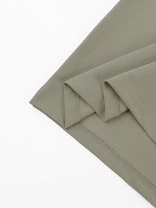 Macro view of olive green pique waffle fabric texture and precision stitching detail