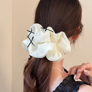 Elegant cream organza oversized scrunchie featuring delicate black bow accents