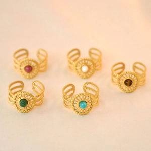 Detailed shot of five gold stainless steel rings with bohemian natural stone inlays